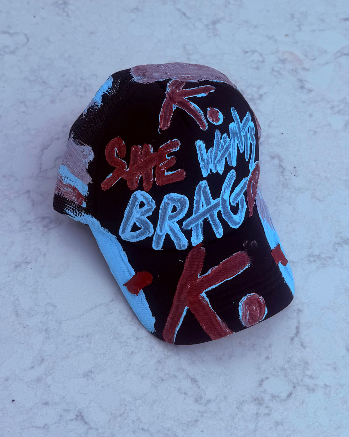 BRAGGER GOT HER K. HAT